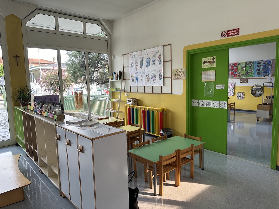 Ambiente educativo per bambini piccoli con tavolini bassi e materiali ordinati